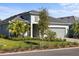 Inviting exterior showcasing a well-manicured lawn, two-car garage, and neutral color scheme at 15931 Sugar Hill Dr, Punta Gorda, FL 33982
