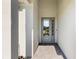 Inviting front entrance featuring a stylish gray door with glass panels and a well-maintained tiled walkway at 15931 Sugar Hill Dr, Punta Gorda, FL 33982