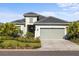 Charming single-Gathering home showcasing a well-manicured lawn, paved driveway, and neutral color palette at 15931 Sugar Hill Dr, Punta Gorda, FL 33982