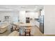 Open kitchen with island seating, stainless appliances, and granite countertops at 15931 Sugar Hill Dr, Punta Gorda, FL 33982