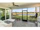 Screened lanai with comfortable seating, offering stunning waterfront views and a built-in grilling area at 15931 Sugar Hill Dr, Punta Gorda, FL 33982