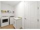 Bright laundry room featuring new washer, dryer, utility sink, and storage at 15931 Sugar Hill Dr, Punta Gorda, FL 33982