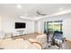 Open-concept living area featuring a large screen TV and sliding doors to the patio at 15931 Sugar Hill Dr, Punta Gorda, FL 33982