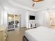 Bright main bedroom with wood-look flooring and access to en-suite bathroom and patio at 15931 Sugar Hill Dr, Punta Gorda, FL 33982