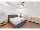 A bright main bedroom featuring a ceiling fan, light wood floors and neutral furniture at 15931 Sugar Hill Dr, Punta Gorda, FL 33982