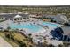 Aerial view showcasing the community pool with plenty of lounge seating and well-maintained landscaping at 15931 Sugar Hill Dr, Punta Gorda, FL 33982