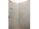 Tiled shower with built-in shelving, neutral color palette, and chrome fixtures at 15931 Sugar Hill Dr, Punta Gorda, FL 33982