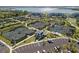 Several tennis courts, a parking lot, and a lake are visible in this aerial view at 15931 Sugar Hill Dr, Punta Gorda, FL 33982