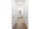 Large walk-in closet with wood-look flooring and views into the en-suite bathroom at 15931 Sugar Hill Dr, Punta Gorda, FL 33982