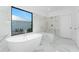Luxurious bathroom featuring marble floors, a soaking tub, and a walk-in shower for a relaxing at-home spa experience at 17476 Vellum Cir, Punta Gorda, FL 33955