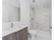 Modern bathroom with marble walk-in shower, floating vanity, and brushed nickel fixtures at 17476 Vellum Cir, Punta Gorda, FL 33955