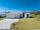 A lovely home with an appealing front exterior, complemented by a well-maintained lawn and a spacious three-car garage at 17476 Vellum Cir, Punta Gorda, FL 33955