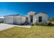 Beautiful home featuring a well-manicured lawn and a three-car garage, providing ample space for vehicles and storage at 17476 Vellum Cir, Punta Gorda, FL 33955