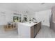 Bright, open kitchen with spacious island and modern appliances seamlessly connected to the dining and living spaces at 17476 Vellum Cir, Punta Gorda, FL 33955