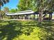 Expansive community pavilion surrounded by trees, offering ample space and shade for outdoor picnics and social gatherings at 17476 Vellum Cir, Punta Gorda, FL 33955