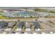 Stunning aerial view of a modern community featuring a scenic pond and well-manicured landscaping at 17860 Palmetto Pass Ln, Punta Gorda, FL 33982