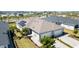 Stunning aerial view of a modern home showcasing a well-manicured lawn and a three car garage at 17860 Palmetto Pass Ln, Punta Gorda, FL 33982
