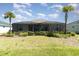 Spacious backyard with a screened-in lanai, mature landscaping and plenty of room for outdoor enjoyment at 17860 Palmetto Pass Ln, Punta Gorda, FL 33982