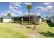 Backyard view featuring screened lanai and landscaping at 17860 Palmetto Pass Ln, Punta Gorda, FL 33982