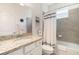 Bright bathroom with granite countertop, modern fixtures, and tub with shower at 17860 Palmetto Pass Ln, Punta Gorda, FL 33982