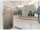 Bathroom features a glass-enclosed shower, double vanity with granite countertop at 17860 Palmetto Pass Ln, Punta Gorda, FL 33982