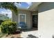 Cozy porch with a blue bench, nautical decor, and a welcoming entrance to the home at 17860 Palmetto Pass Ln, Punta Gorda, FL 33982