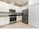 Bright kitchen features stainless steel appliances, granite countertops, and ample white cabinetry at 17860 Palmetto Pass Ln, Punta Gorda, FL 33982