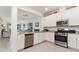 Bright white kitchen with stainless steel appliances and ample counter space at 17860 Palmetto Pass Ln, Punta Gorda, FL 33982