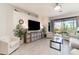 Bright and airy living room with tile flooring and sliding glass doors to the lanai at 17860 Palmetto Pass Ln, Punta Gorda, FL 33982