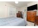 Comfortable main bedroom featuring a large window and a view of ensuite bathroom at 17860 Palmetto Pass Ln, Punta Gorda, FL 33982