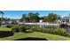 A lush green backyard that borders a canal, complete with a private dock and lift at 18427 Goodman Cir, Port Charlotte, FL 33948