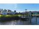 Home's landscaped backyard and private dock, featuring boat lift, on waterfront canal at 18427 Goodman Cir, Port Charlotte, FL 33948