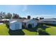This property features a large manicured backyard with a storage shed and a screened lanai at 18427 Goodman Cir, Port Charlotte, FL 33948