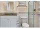Bathroom featuring granite counters, a tiled shower with glass door, and neutral decor at 18427 Goodman Cir, Port Charlotte, FL 33948