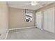 Bedroom featuring grey flooring, neutral walls, a window, and closet space at 18427 Goodman Cir, Port Charlotte, FL 33948