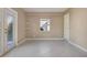 Bedroom featuring tiled floors, neutral walls, large window, and door to the exterior at 18427 Goodman Cir, Port Charlotte, FL 33948
