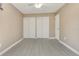 Spacious bedroom with wood-look floors, closet, and neutral-painted walls at 18427 Goodman Cir, Port Charlotte, FL 33948