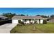Charming single-story home with attached garage and well-maintained lawn, offering comfortable living at 18427 Goodman Cir, Port Charlotte, FL 33948