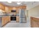 Spacious kitchen featuring stainless steel appliances and light wood cabinets and light ceramic tile floors at 18427 Goodman Cir, Port Charlotte, FL 33948