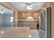 Kitchen boasts granite countertops, light wood cabinets, stainless appliances, and ceramic tile flooring at 18427 Goodman Cir, Port Charlotte, FL 33948