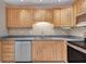 Kitchen featuring updated appliances and light-colored wood cabinets with complimentary granite countertops at 18427 Goodman Cir, Port Charlotte, FL 33948