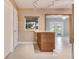 Bright kitchen with light wood cabinetry, granite counters, tile flooring, and ample natural light at 18427 Goodman Cir, Port Charlotte, FL 33948