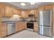 Well-equipped kitchen featuring modern stainless-steel appliances, and light wood cabinets at 18427 Goodman Cir, Port Charlotte, FL 33948