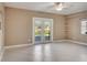 Living room featuring tiled floors, neutral walls, and natural light from the French doors at 18427 Goodman Cir, Port Charlotte, FL 33948