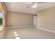 Spacious living room featuring neutral walls, tile flooring, and a bright window at 18427 Goodman Cir, Port Charlotte, FL 33948
