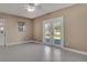 Bright living room features tile floors, neutral walls and French doors offering backyard views at 18427 Goodman Cir, Port Charlotte, FL 33948
