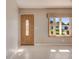 Bright living room with a decorative front door, bay window, and tiled floors at 18427 Goodman Cir, Port Charlotte, FL 33948