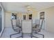 This cozy screened patio features tile floors and a ceiling fan over the outdoor dining set at 18427 Goodman Cir, Port Charlotte, FL 33948