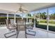 Enclosed lanai features tile flooring and panoramic views of the backyard and landscaping at 18427 Goodman Cir, Port Charlotte, FL 33948