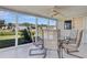 Sunroom featuring a ceiling fan, tile flooring, and waterfront views at 18427 Goodman Cir, Port Charlotte, FL 33948
